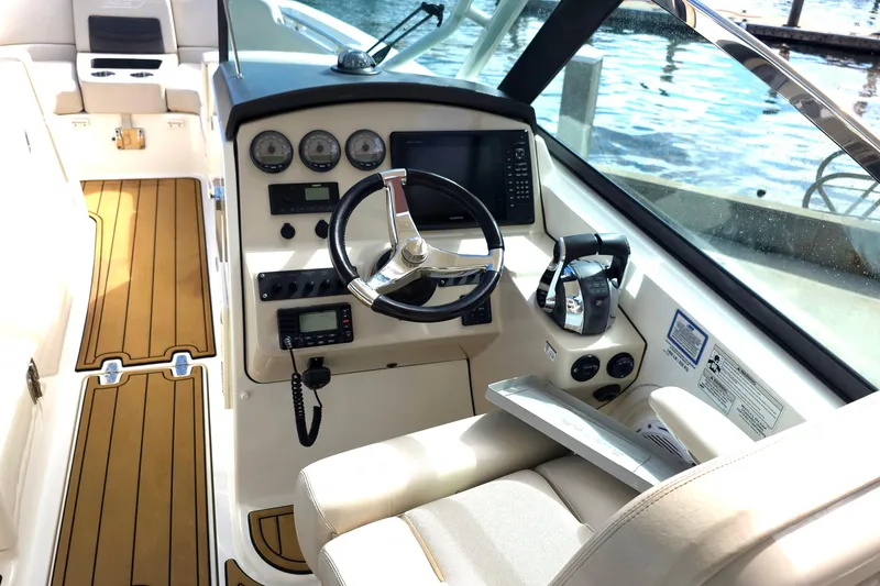 Slide: The Image of 2015 Boston Whaler 270 Vantage helm with modern controls and wood-accented flooring. - 43