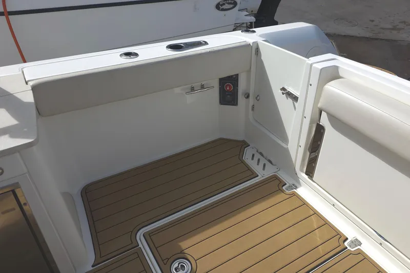 Slide: The Image of 2015 Boston Whaler 270 Vantage boat interior with teak flooring and seating area. - 51