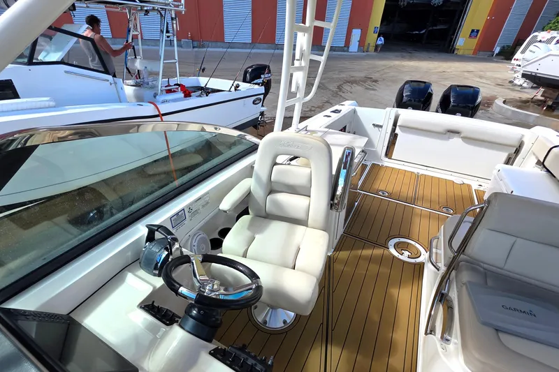 Slide: The Image of 2015 Boston Whaler 270 Vantage boat interior with helm, seating, and teak flooring. - 54