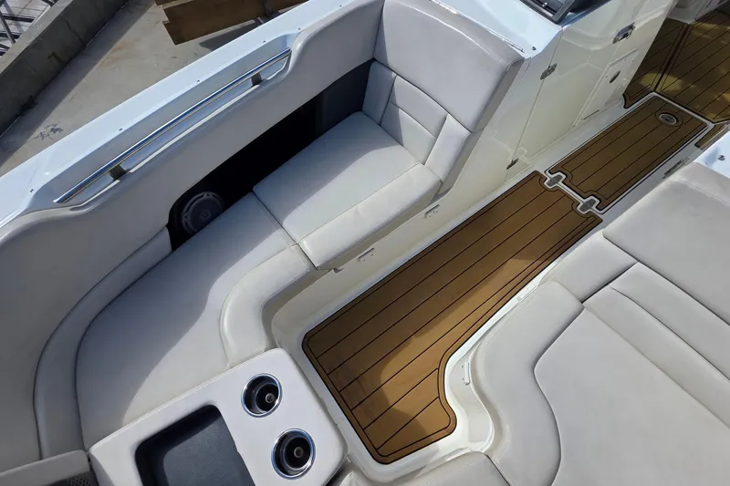 Slide: The Image of 2015 Boston Whaler 270 Vantage interior with cushioned seating and teak-style flooring. - 57