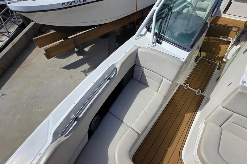 Slide: The Image of 2015 Boston Whaler 270 Vantage boat interior with cushioned seating and teak flooring. - 59