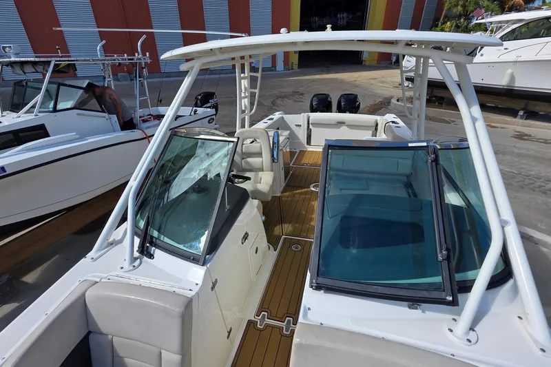 Slide: The Image of 2015 Boston Whaler 270 Vantage boat with dual engines and spacious deck layout. - 9