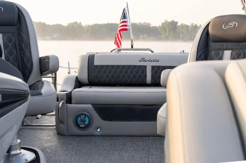 Slide: The Image of Manufacturer Provided Image: 2026 Barletta Lusso 25UC pontoon boat interior with luxury seating and American flag. - 10