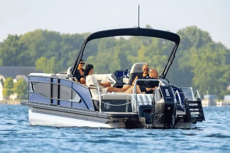 Slide: The Image of Manufacturer Provided Image: 2026 Barletta Lusso 25UC pontoon boat cruising on a lake with passengers. - 8