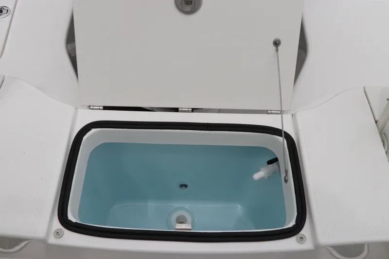 Slide: The Image of Open storage compartment on 2026 Robalo R200 Center Console boat. - 11