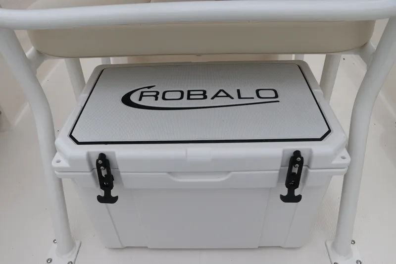 Slide: The Image of 2026 Robalo R200 Center Console cooler under seat, featuring secure latches. - 14
