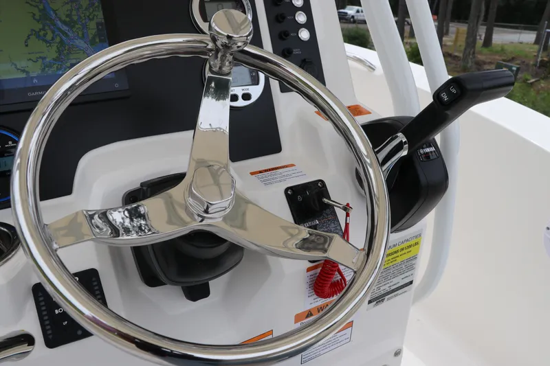 Slide: The Image of Steering wheel and controls of 2026 Robalo R200 Center Console boat. - 19