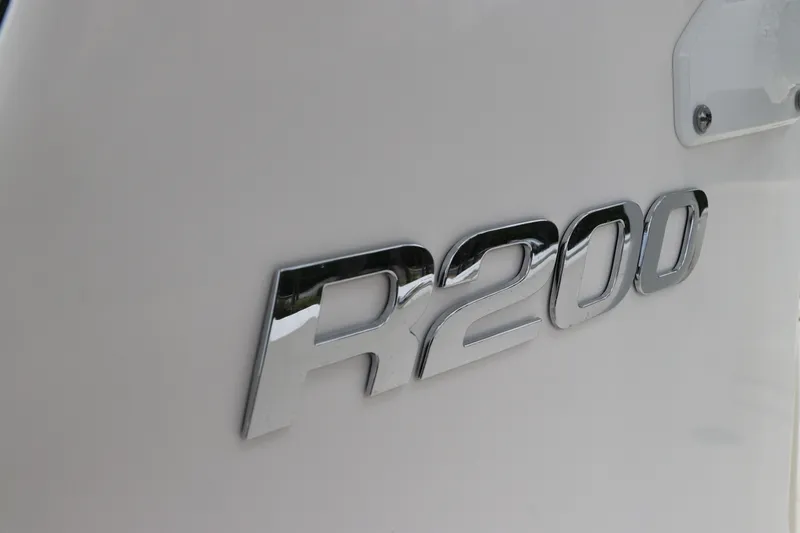 Slide: The Image of Chrome "R200" emblem on 2026 Robalo R200 Center Console boat. - 30