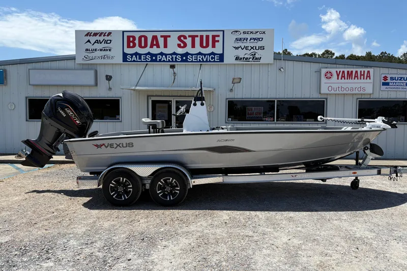 The Image of 2026 Vexus ACX 2150 boat on trailer outside dealership, featuring Yamaha outboard motor. - 1