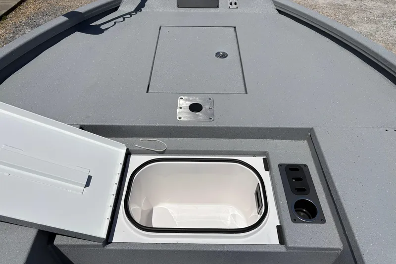 Slide: The Image of 2026 Vexus ACX 2150 boat deck with open storage compartment and cup holders. - 10