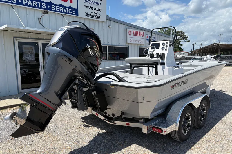Slide: The Image of 2026 Vexus ACX 2150 boat with Yamaha outboard motor, parked outside dealership. - 3