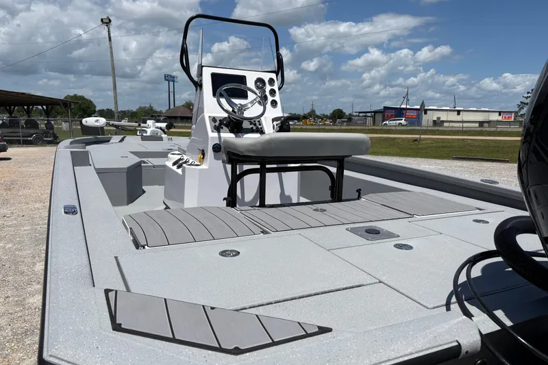 Slide: The Image of 2026 Vexus ACX 2150 boat with sleek design and modern console, under a partly cloudy sky. - 5