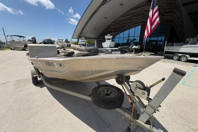 Slide: The Image of 2010 Custom Hanko 16' Side Console boat on trailer, parked outside a building. - 10