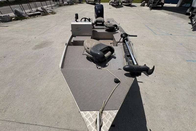 Slide: The Image of 2010 Custom Hanko 16' Side Console boat on concrete surface, featuring a trolling motor. - 11