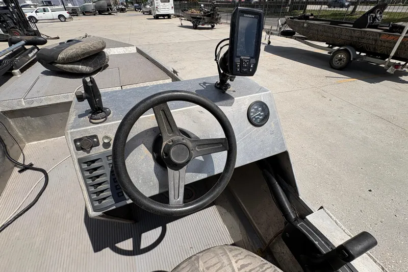 Slide: The Image of Steering console of a 2010 Custom Hanko 16' Side Console boat with navigation equipment. - 15