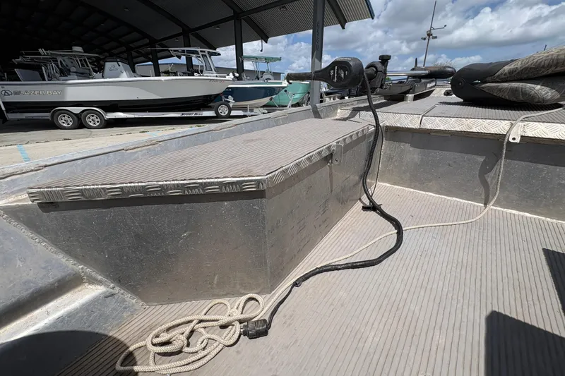 Slide: The Image of 2010 Custom Hanko 16' Side Console boat interior with equipment and docked vessels. - 16