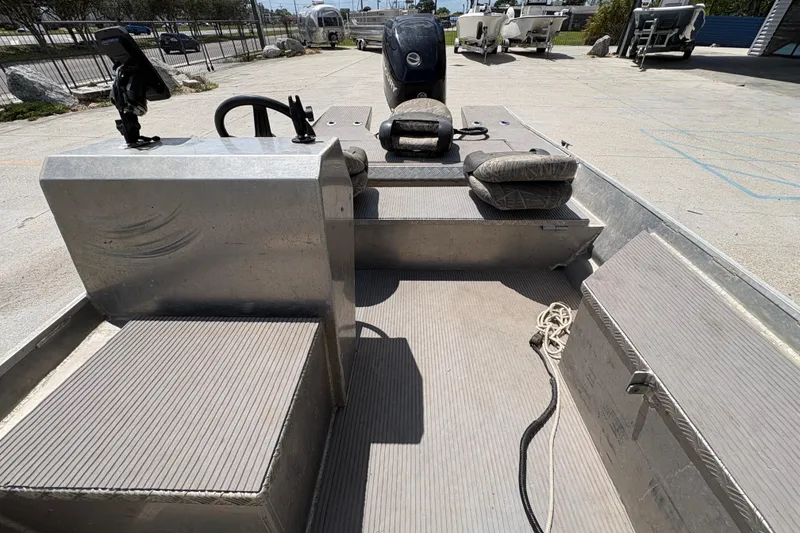 Slide: The Image of 2010 Custom Hanko 16' Side Console boat interior with seating and controls. - 19