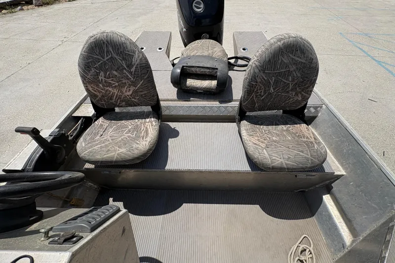 Slide: The Image of 2010 Custom Hanko 16' Side Console boat with camo seats and steering console. - 20