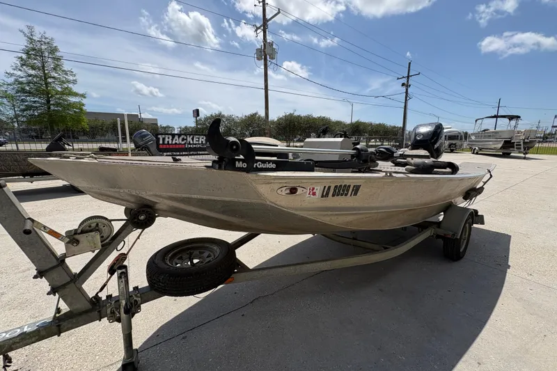 Slide: The Image of Custom 2010 Hanko 16' Side Console boat on trailer under clear sky. - 8