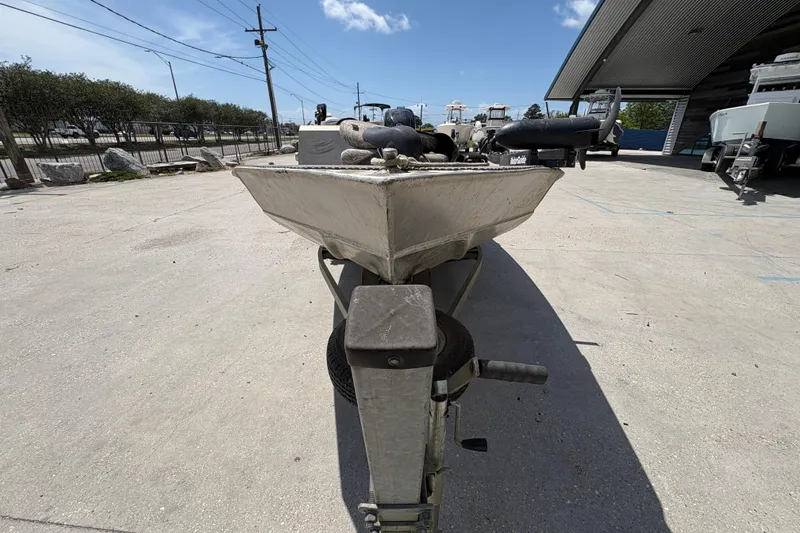 Slide: The Image of 2010 Custom Hanko 16' Side Console boat on trailer, parked outdoors under blue sky. - 9