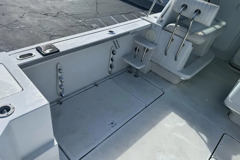 Slide: The Image of 2000 Glacier Bay 2680 Coastal Runner boat interior with seating and storage compartments. - 12