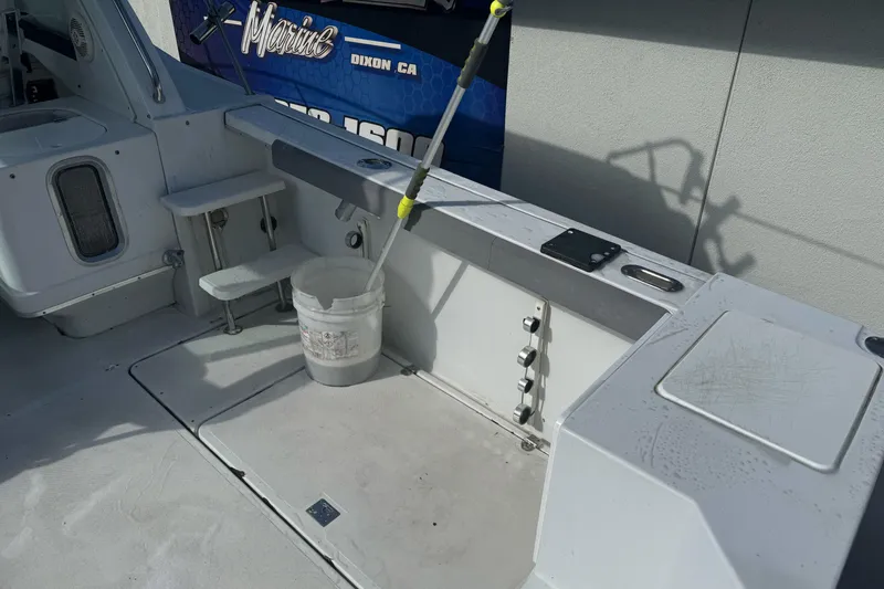 Slide: The Image of 2000 Glacier Bay 2680 Coastal Runner boat deck with fishing gear and storage compartments. - 13