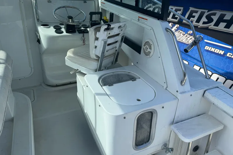 Slide: The Image of Interior of 2000 Glacier Bay 2680 Coastal Runner boat with steering wheel and seating. - 15