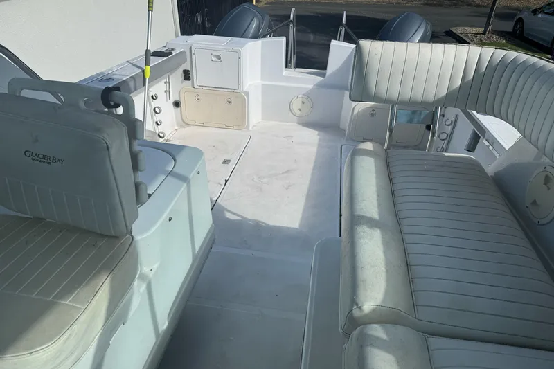 Slide: The Image of Interior view of a 2000 Glacier Bay 2680 Coastal Runner boat with seating and storage. - 17