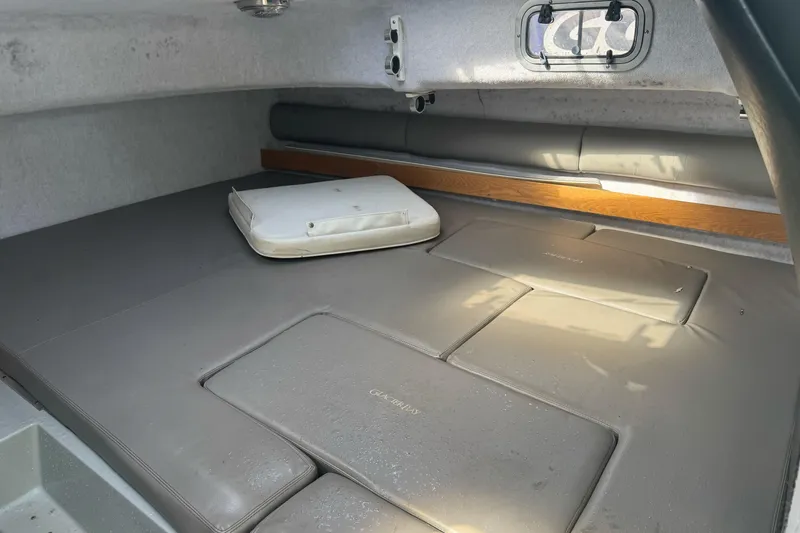 Slide: The Image of Interior cabin of a 2000 Glacier Bay 2680 Coastal Runner boat, featuring cushioned seating. - 21