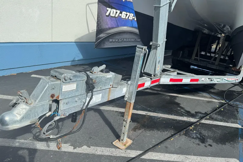 Slide: The Image of Trailer hitch of a 2000 Glacier Bay 2680 Coastal Runner boat in a parking lot. - 5