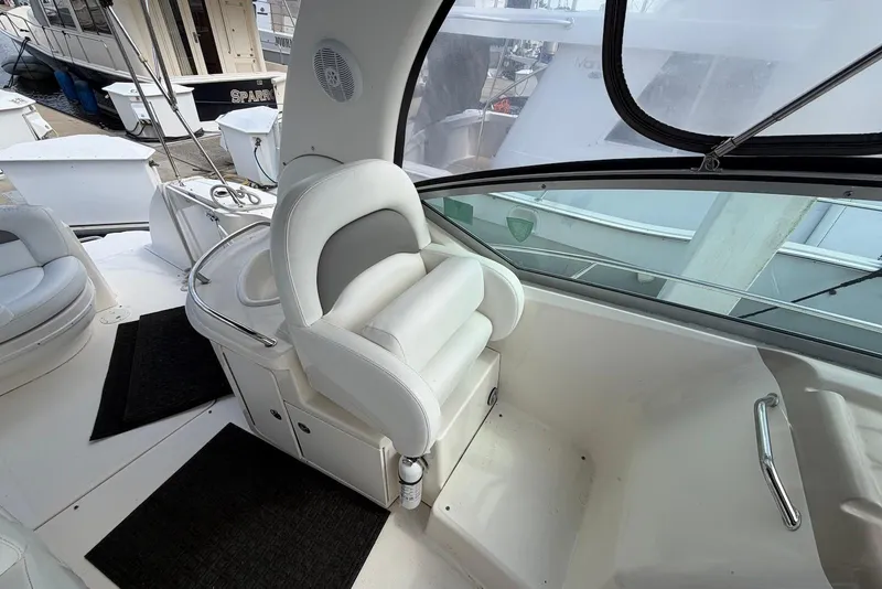 Slide: The Image of Interior of a 2003 Sea Ray 340 Sundancer boat with white seating and helm area. - 11