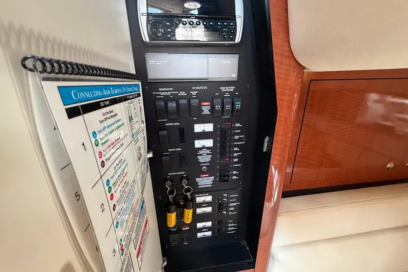 Slide: The Image of Electrical control panel on a 2003 Sea Ray 340 Sundancer boat interior. - 12
