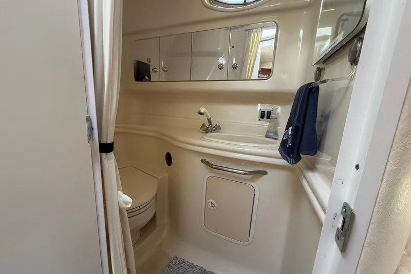 Slide: The Image of 2003 Sea Ray 340 Sundancer bathroom with sink, mirror, and storage cabinets. - 15