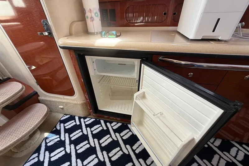 Slide: The Image of Open mini fridge inside 2003 Sea Ray 340 Sundancer yacht cabin. - 18