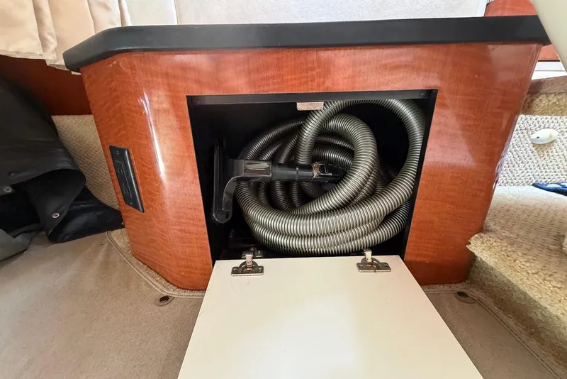 Slide: The Image of Storage compartment with coiled hose in 2003 Sea Ray 340 Sundancer boat interior. - 21