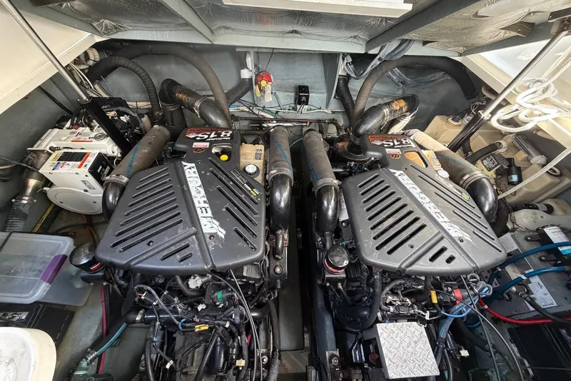 Slide: The Image of Engine room of a 2003 Sea Ray 340 Sundancer with twin engines and mechanical components. - 22
