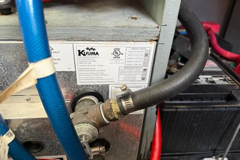 Slide: The Image of Kuuma marine heater with hoses and labels on a 2003 Sea Ray 340 Sundancer boat. - 26