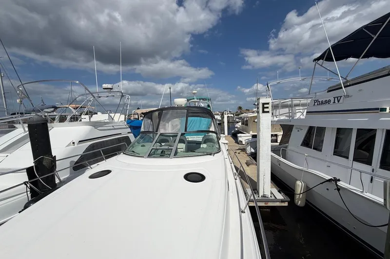 Slide: The Image of 2003 Sea Ray 340 Sundancer docked at marina under cloudy sky. - 5