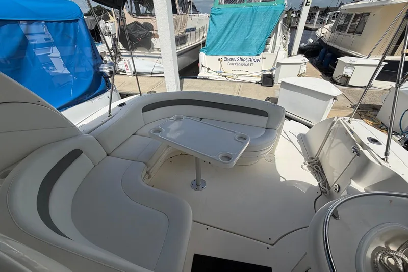 Slide: The Image of 2003 Sea Ray 340 Sundancer boat interior with seating and table at marina. - 6