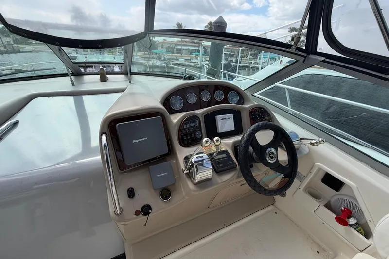 Slide: The Image of 2003 Sea Ray 340 Sundancer helm with navigation instruments and steering wheel. - 8
