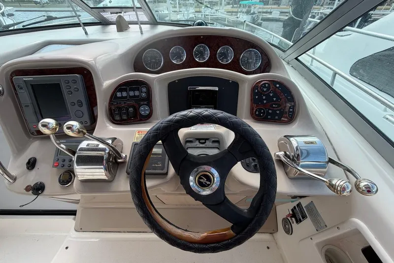 Slide: The Image of Cockpit of 2003 Sea Ray 340 Sundancer with steering wheel and control panel. - 9