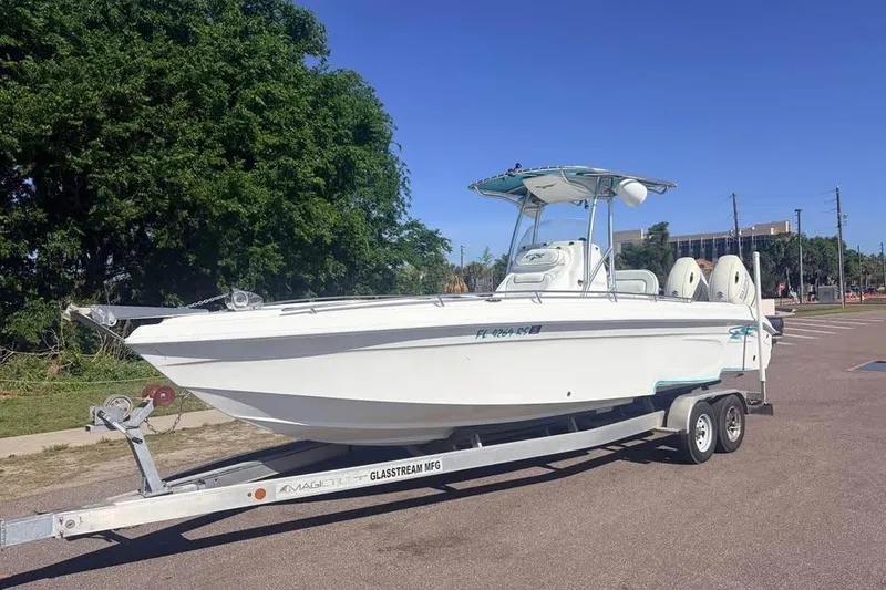 The Image of 2018 Glasstream 280 Pro-XS boat on trailer, parked outdoors under clear blue sky. - 0