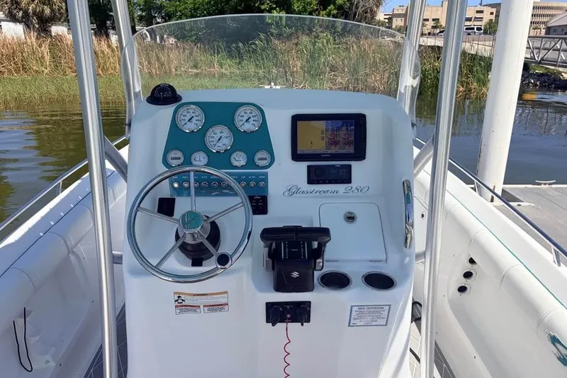 Slide: The Image of 2018 Glasstream 280 Pro-XS boat dashboard with steering wheel and navigation instruments. - 10