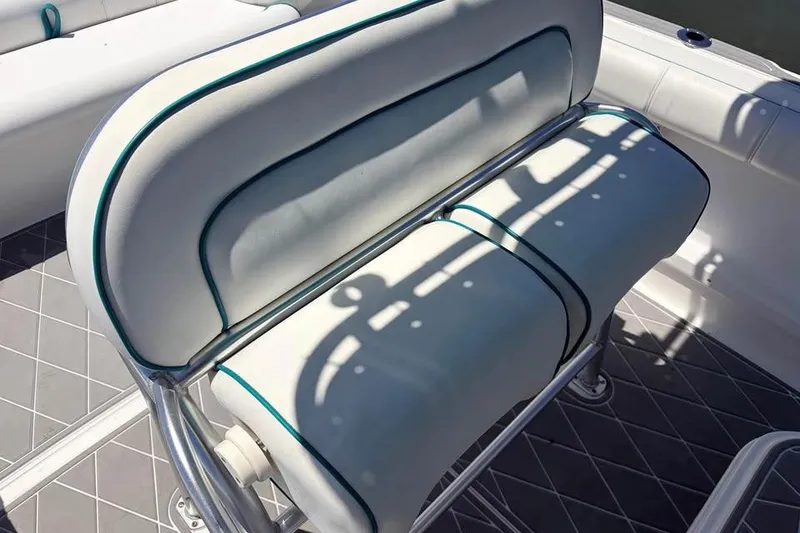Slide: The Image of 2018 Glasstream 280 Pro-XS boat seating with white cushions and teal accents. - 15