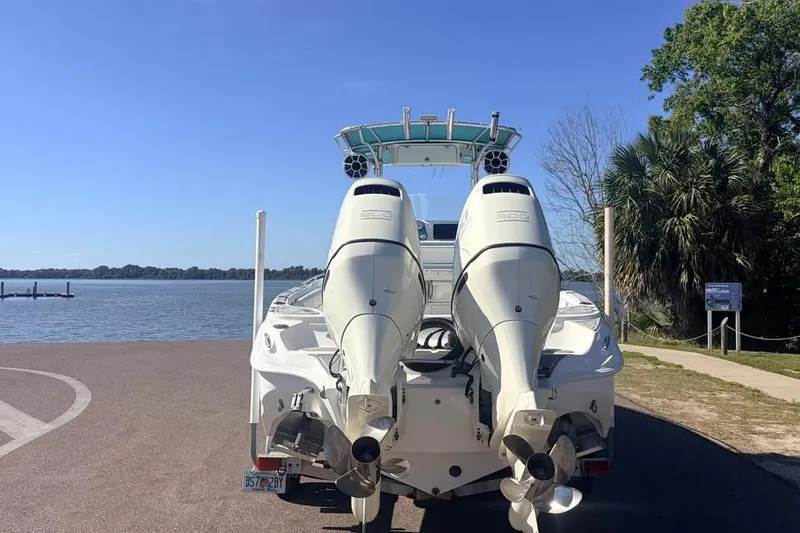 Slide: The Image of 2018 Glasstream 280 Pro-XS boat with dual engines by a lakeside. - 2