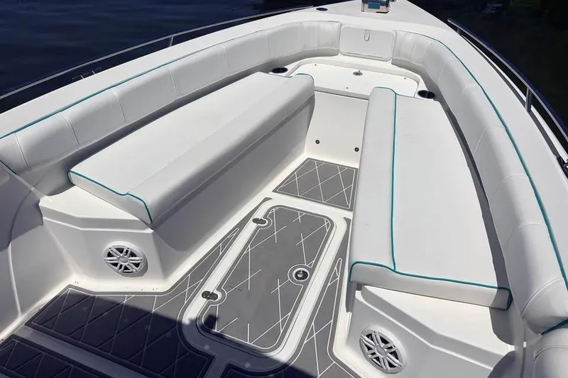 Slide: The Image of Spacious seating area on 2018 Glasstream 280 Pro-XS boat with cushioned benches and speakers. - 6
