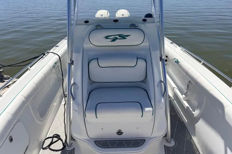 Slide: The Image of 2018 Glasstream 280 Pro-XS boat interior with white seating and logo, on calm water. - 7