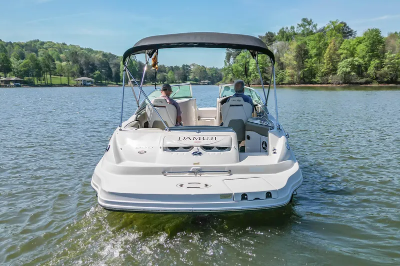 Slide: The Image of 2007 Sea Ray 220 Sundeck boat cruising on a scenic lake. - 2