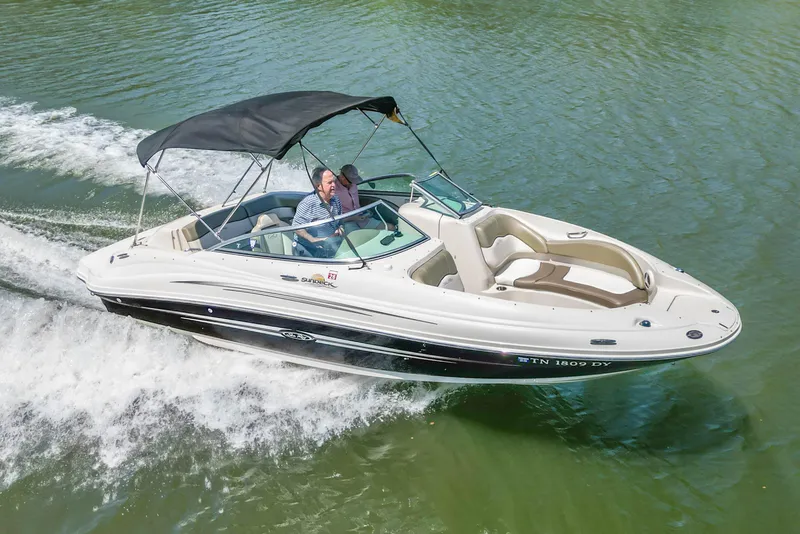 Slide: The Image of 2007 Sea Ray 220 Sundeck cruising on a lake with passengers onboard. - 3