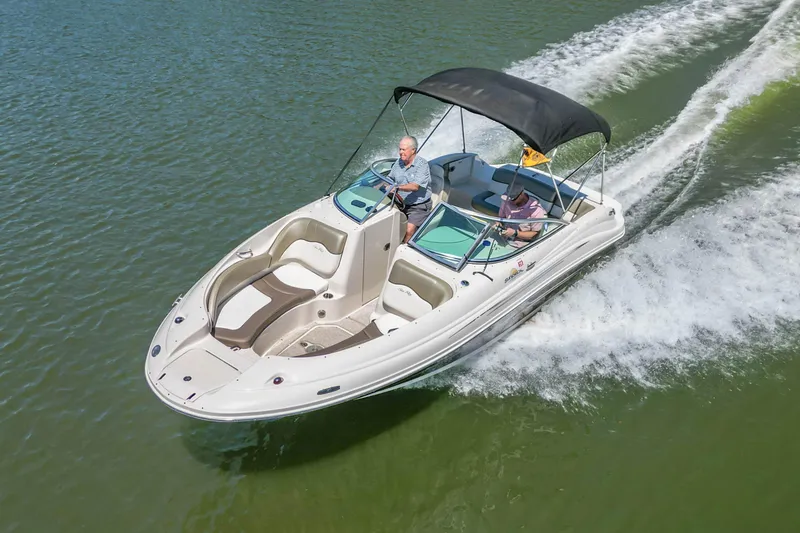Slide: The Image of 2007 Sea Ray 220 Sundeck cruising on a lake with two passengers. - 7